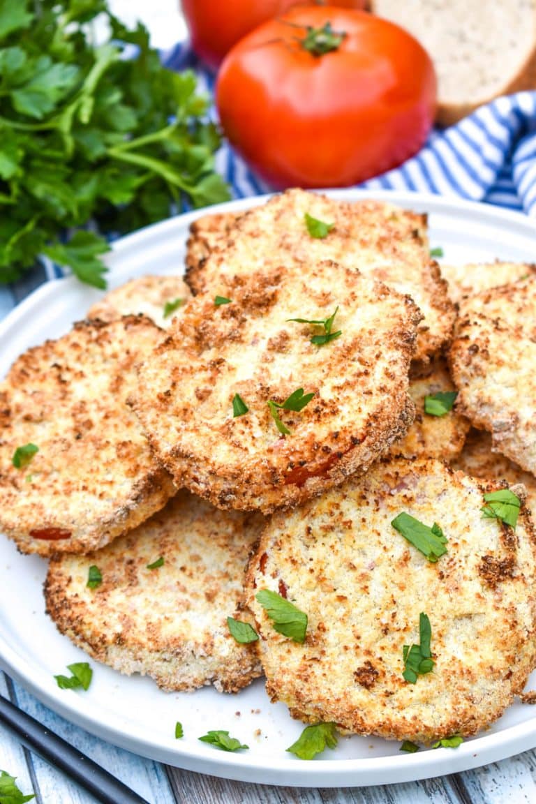 air fryer fried red tomatoes piled on a white plate