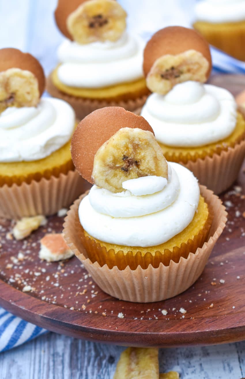 banana pudding cupcakes on a wooden cake stand