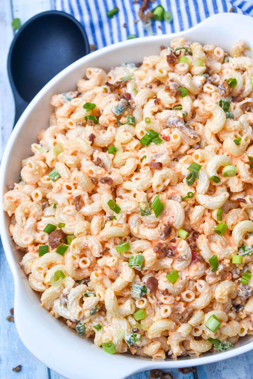 pimento cheese macaroni salad in a large white serving bowl