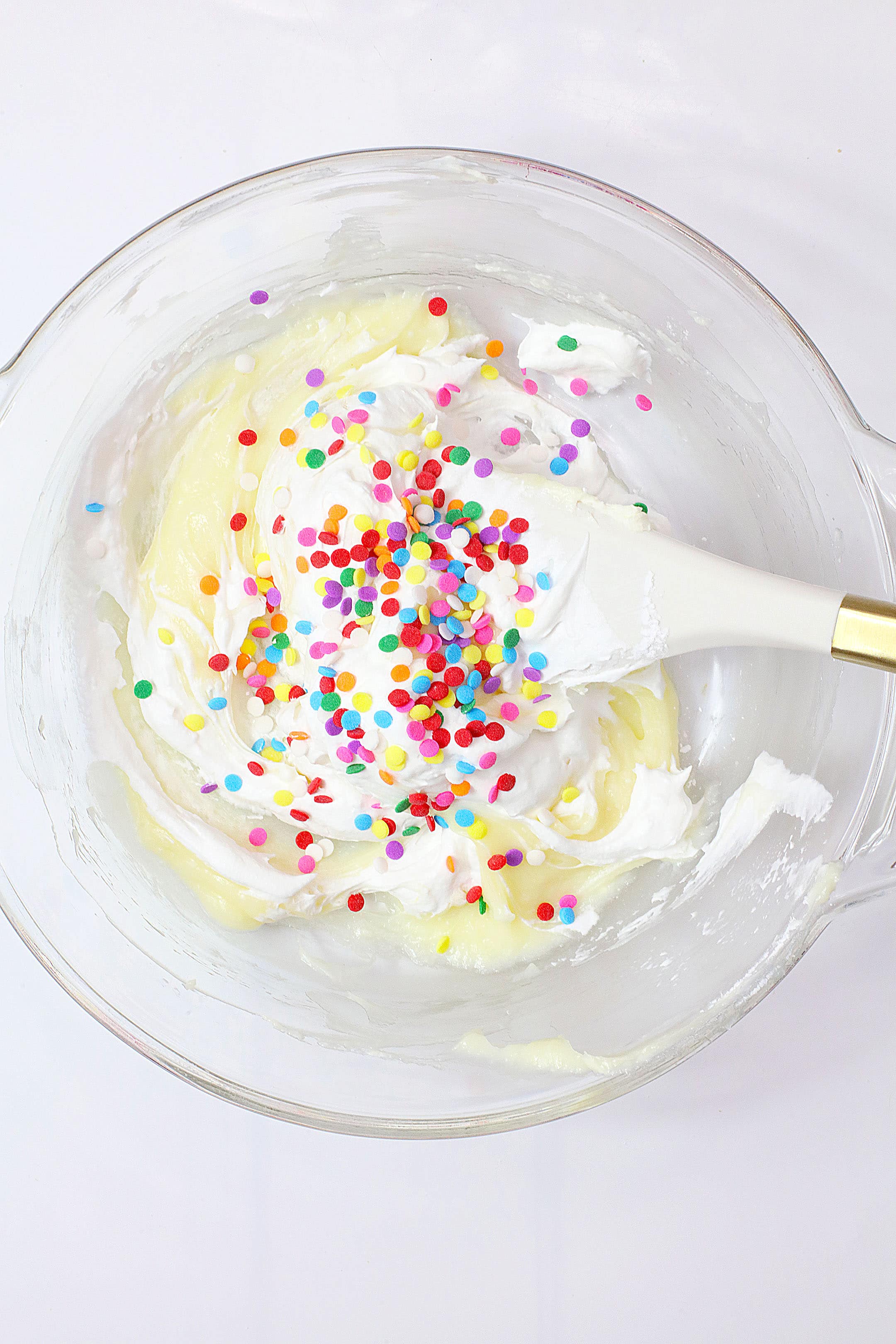 cake batter pie filling with sprinkles in a glass mixing bowl