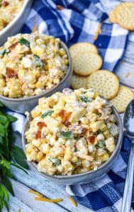 jalapeno popper grilled corn salad in two small gray bowls on a wooden table