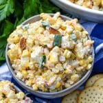 jalapeno popper grilled corn salad in two small gray bowls on a wooden table