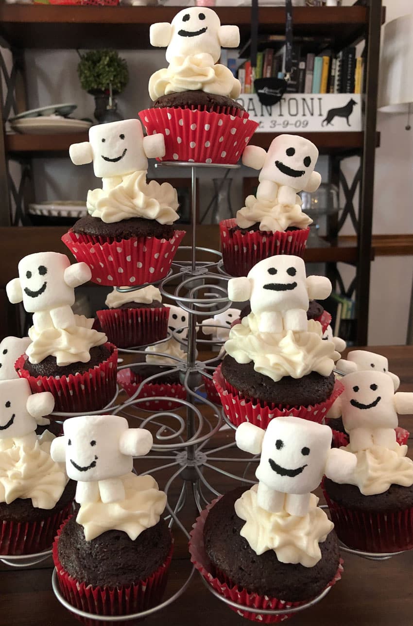 adipose marshmallows on chocolate cupcakes on a cupcake stand