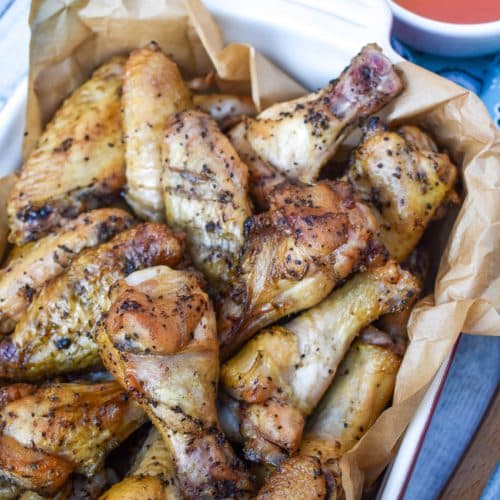 smoked chicken wings in a parchment paper lined baking dish