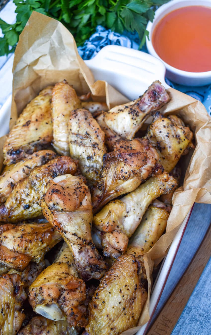 smoked chicken wings in a parchment paper lined baking dish