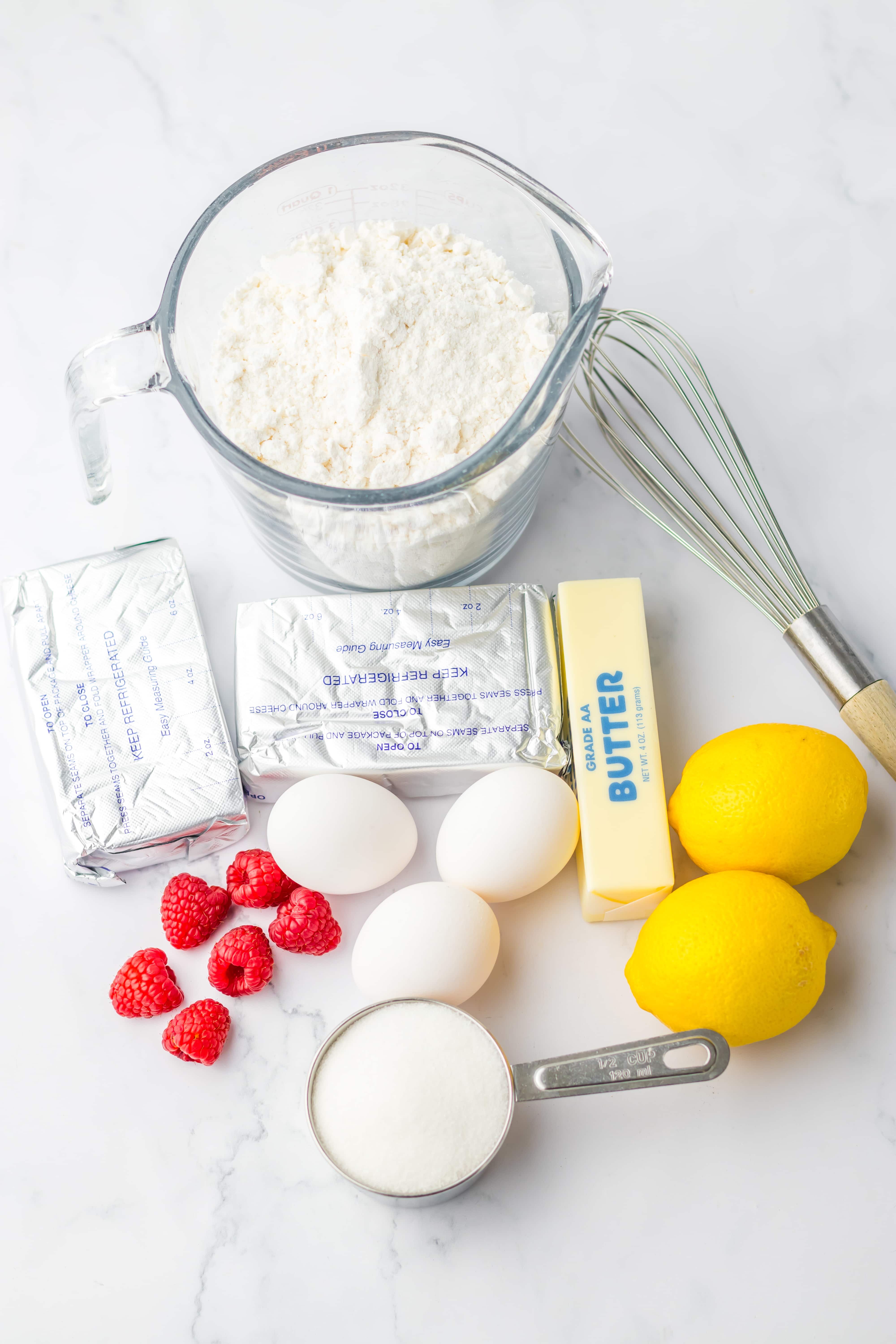 an overhead image showing the measured ingredients needed to make a batch of raspberry lemon cheesecake bars