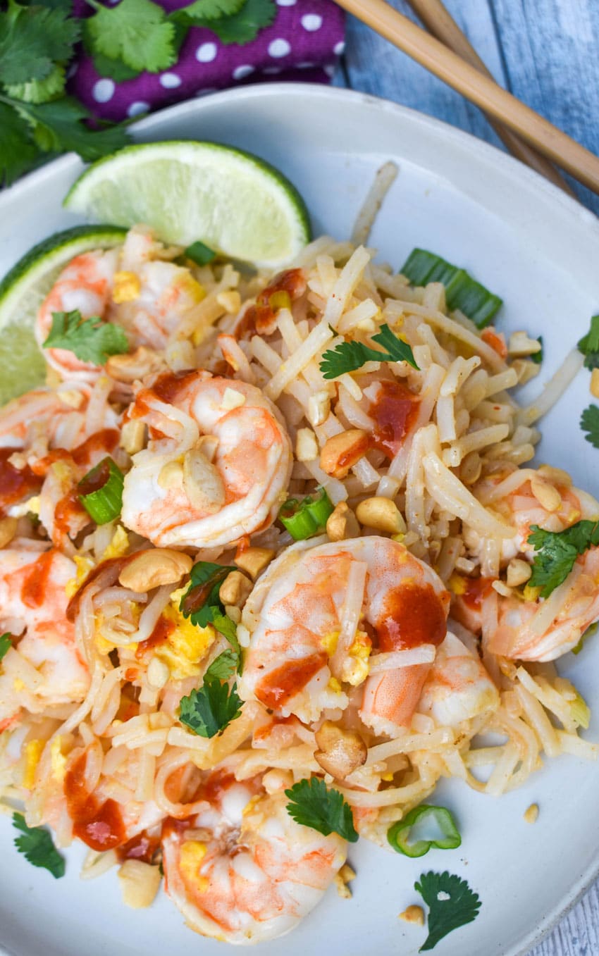 a close up of homemade shrimp pad thai on a white plate