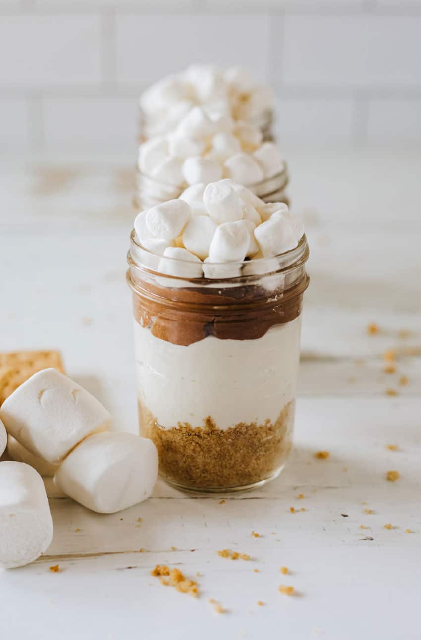 marshmallow topped layered s'mores trifles in a small glass jar