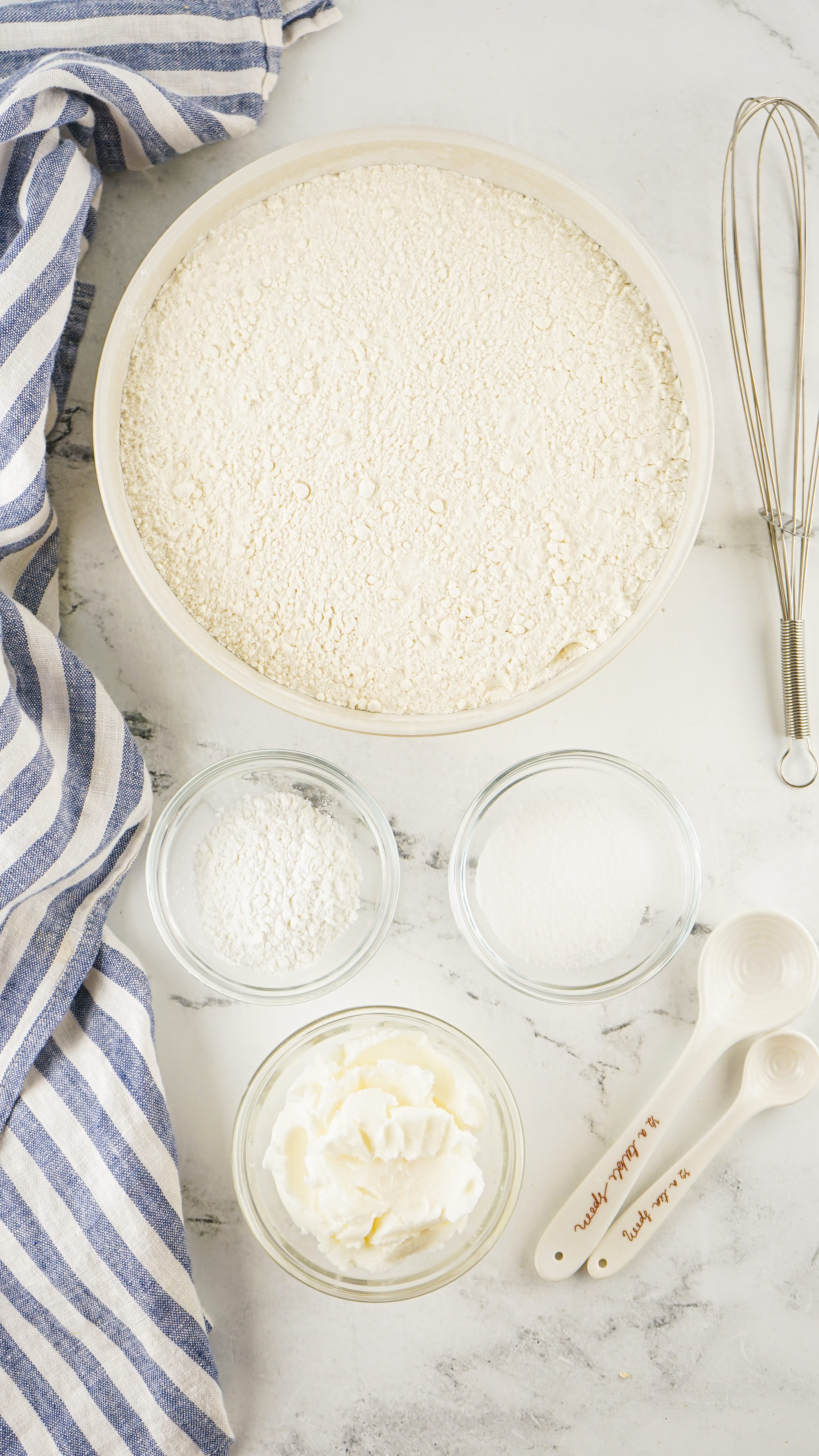 an overhead image showing the measured ingredients needed to make homemade bisquick