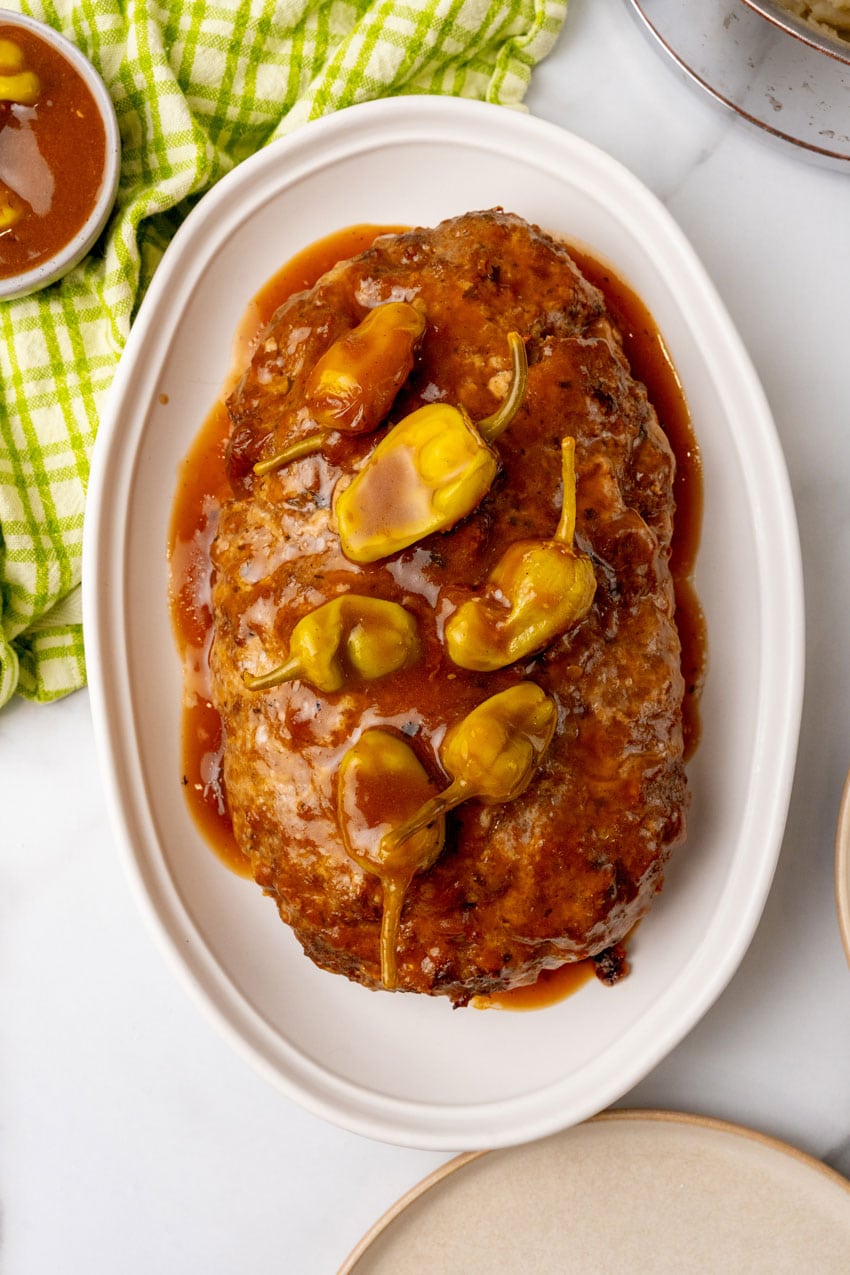 mississippi meatloaf with gravy on a white serving platter