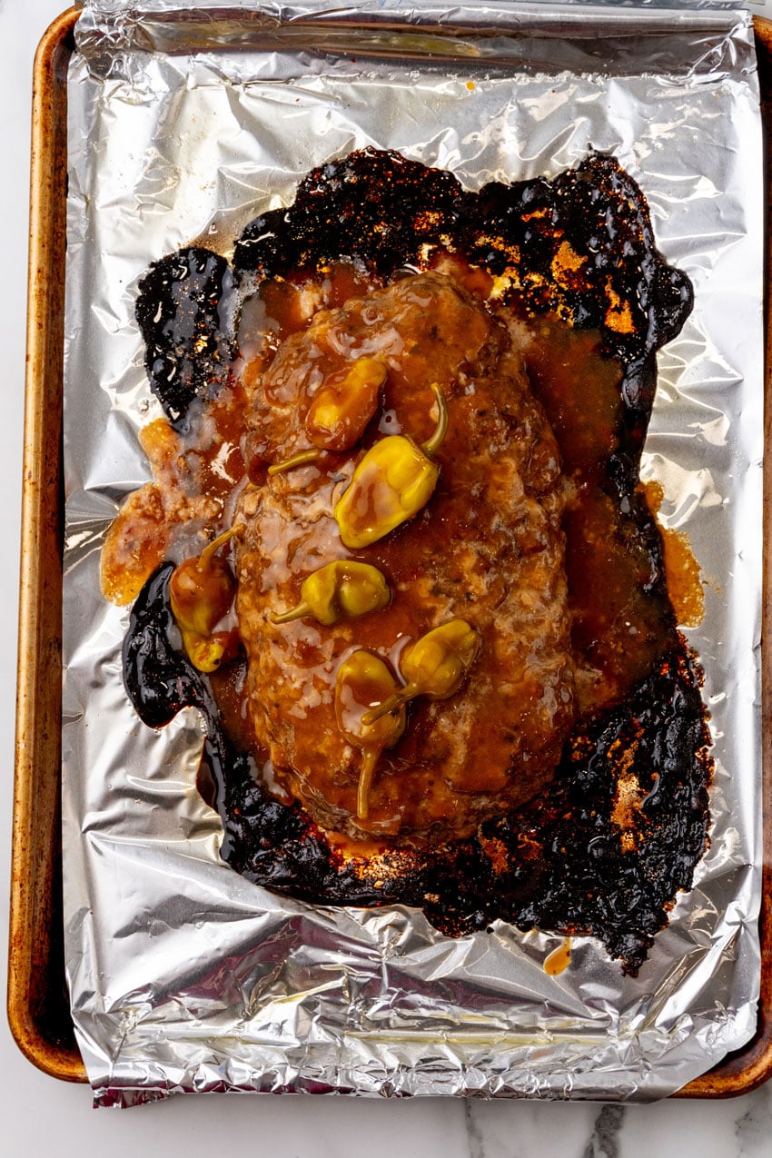 a baked mississippi meatloaf on a foil lined baking sheet