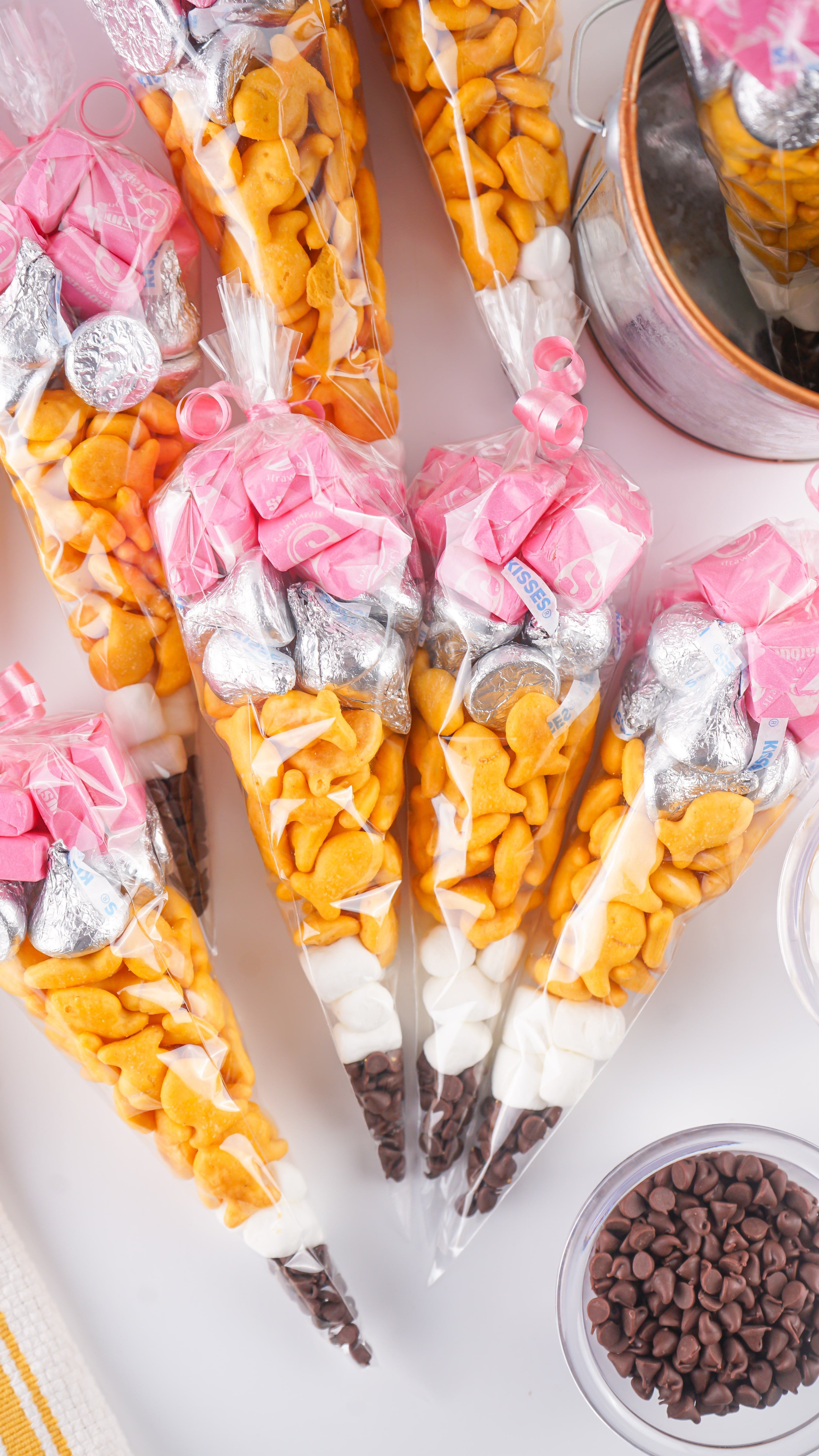 A PILE OF BACK TO SCHOOL TREAT BAGS ON A WHITE COUNTERTOP 