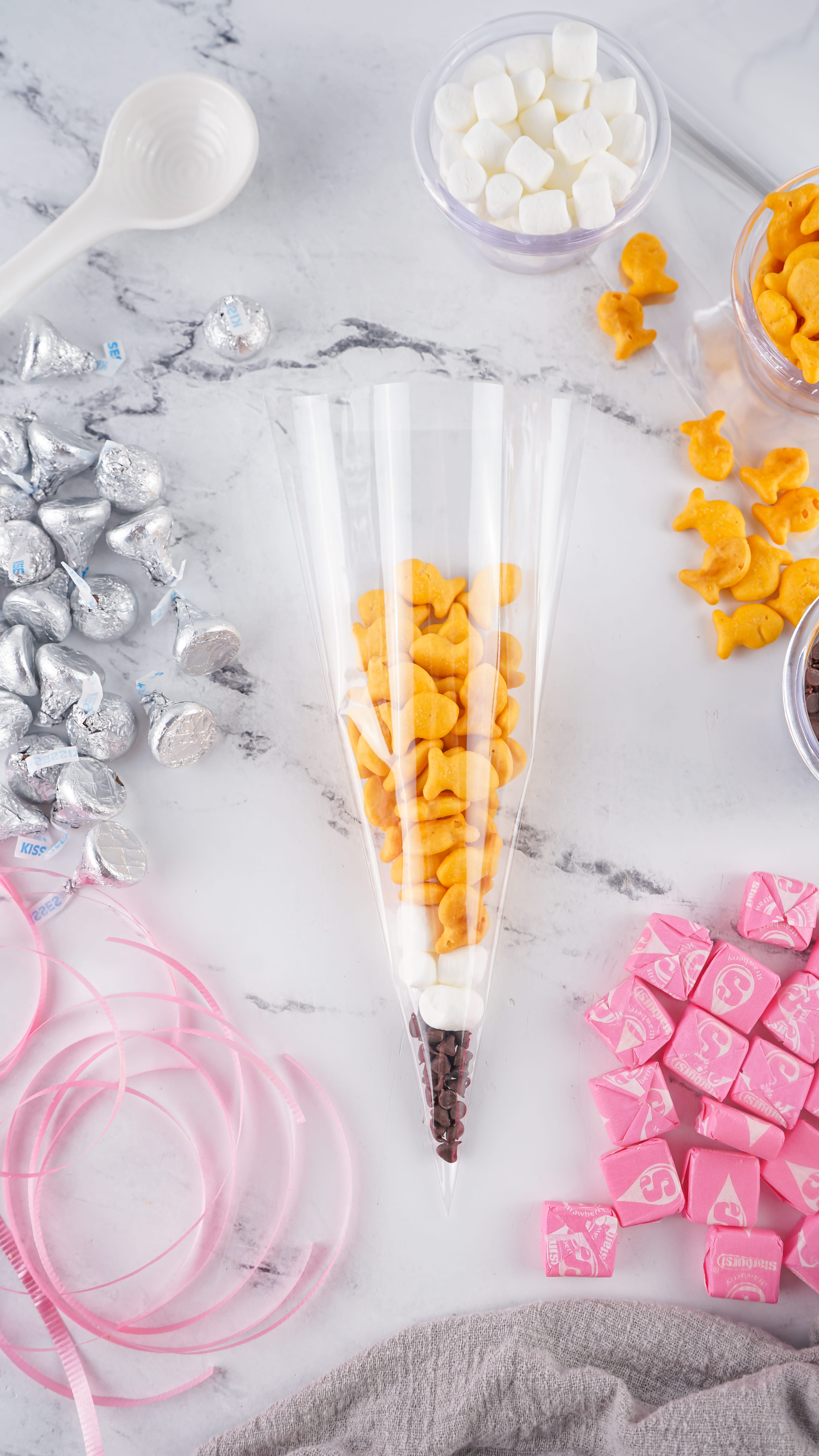 an overhead image showing how to fill the layers of an back to school pencil treat bag