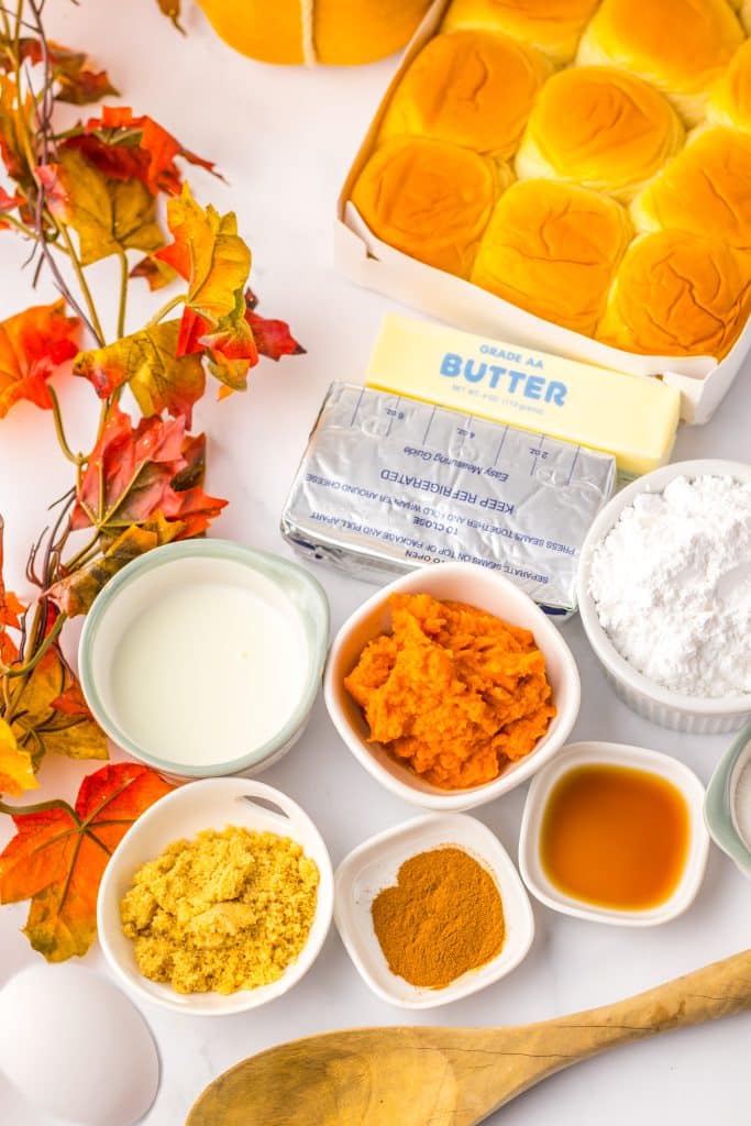 an overhead image showing the measured ingredients needed to make a batch of pumpkin danish hawaiian rolls