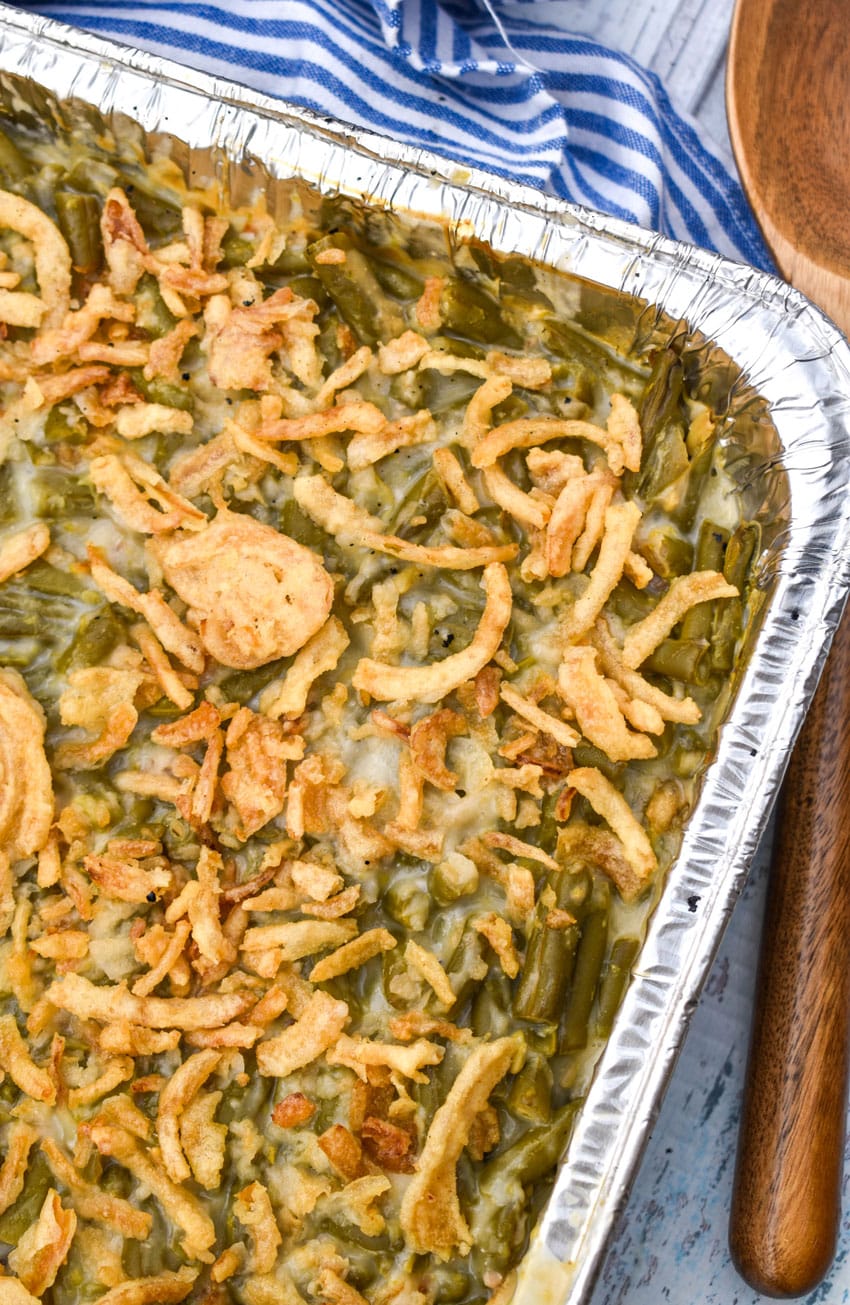 smoked green bean casserole in a disposable aluminum pan