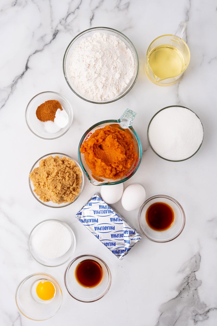 an overhead image showing the measured ingredients needed to make a batch of pumpkin cream cheese swirl muffins