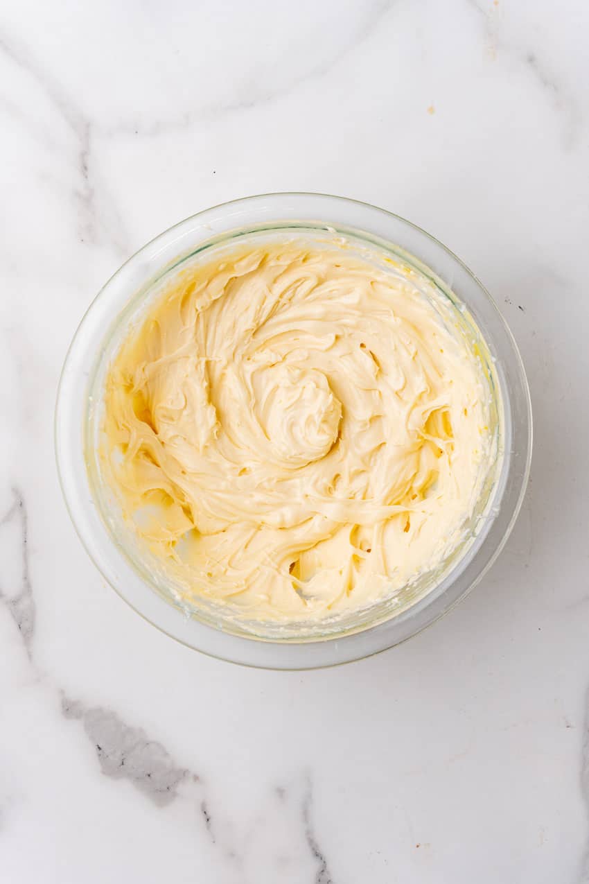 whipped cream cheese in a glass mixing bowl