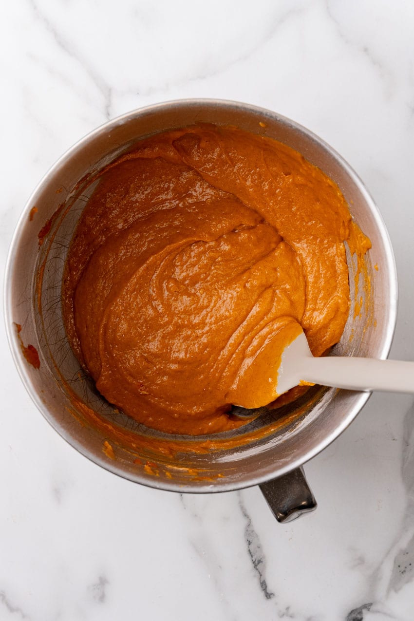 pumpkin muffin batter in a metal mixing bowl