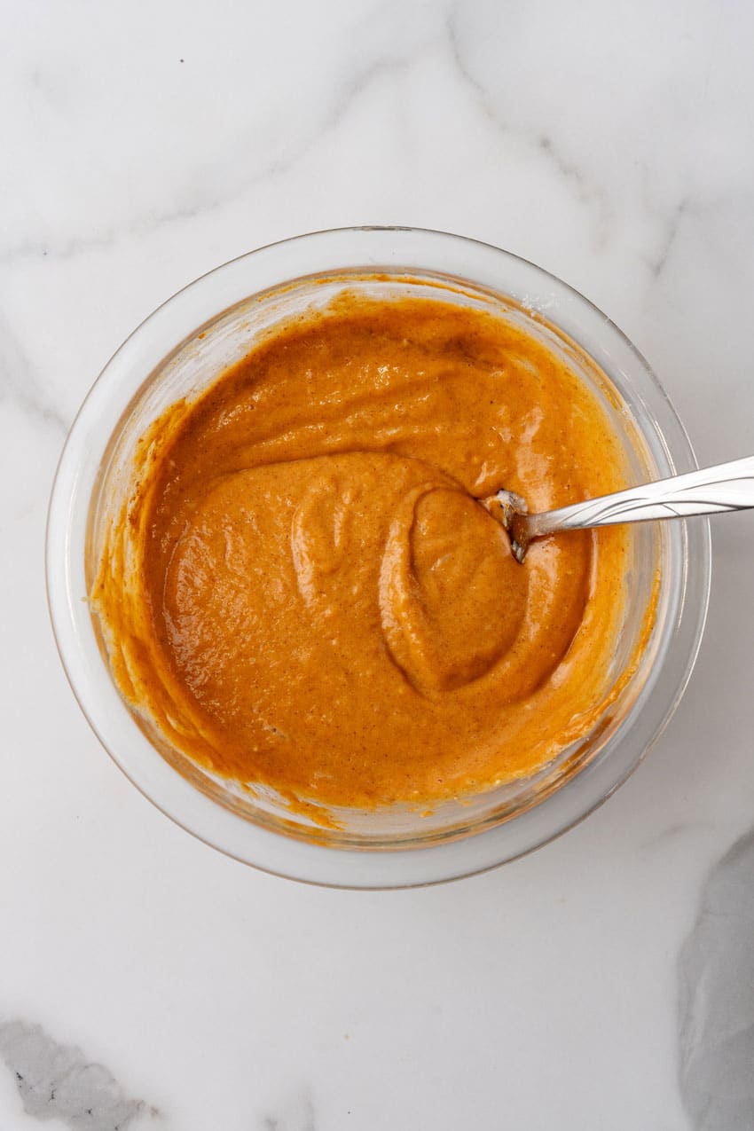 sweetened pumpkin filling in a glass mixing bowl