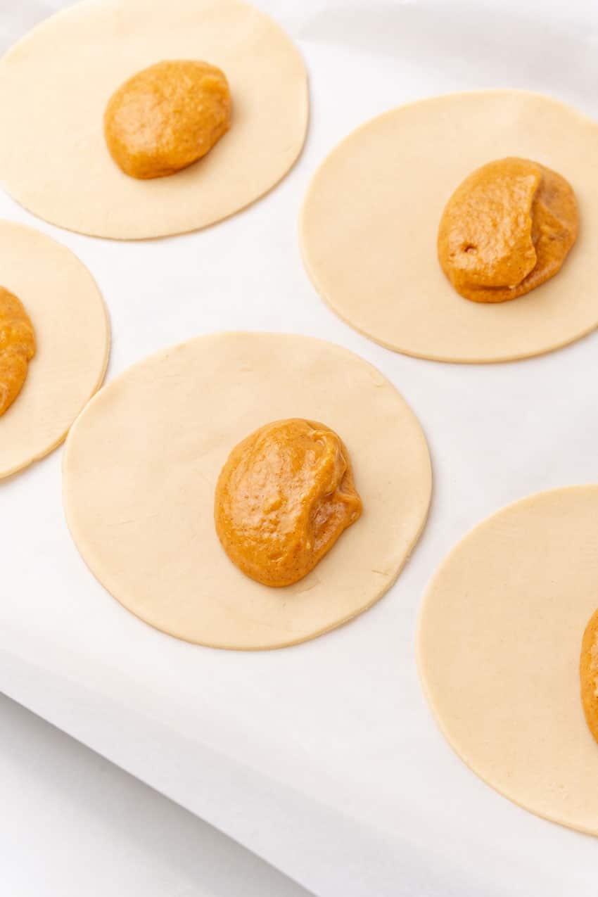 dollops of sweet pumpkin filling on pie crust circle cutouts