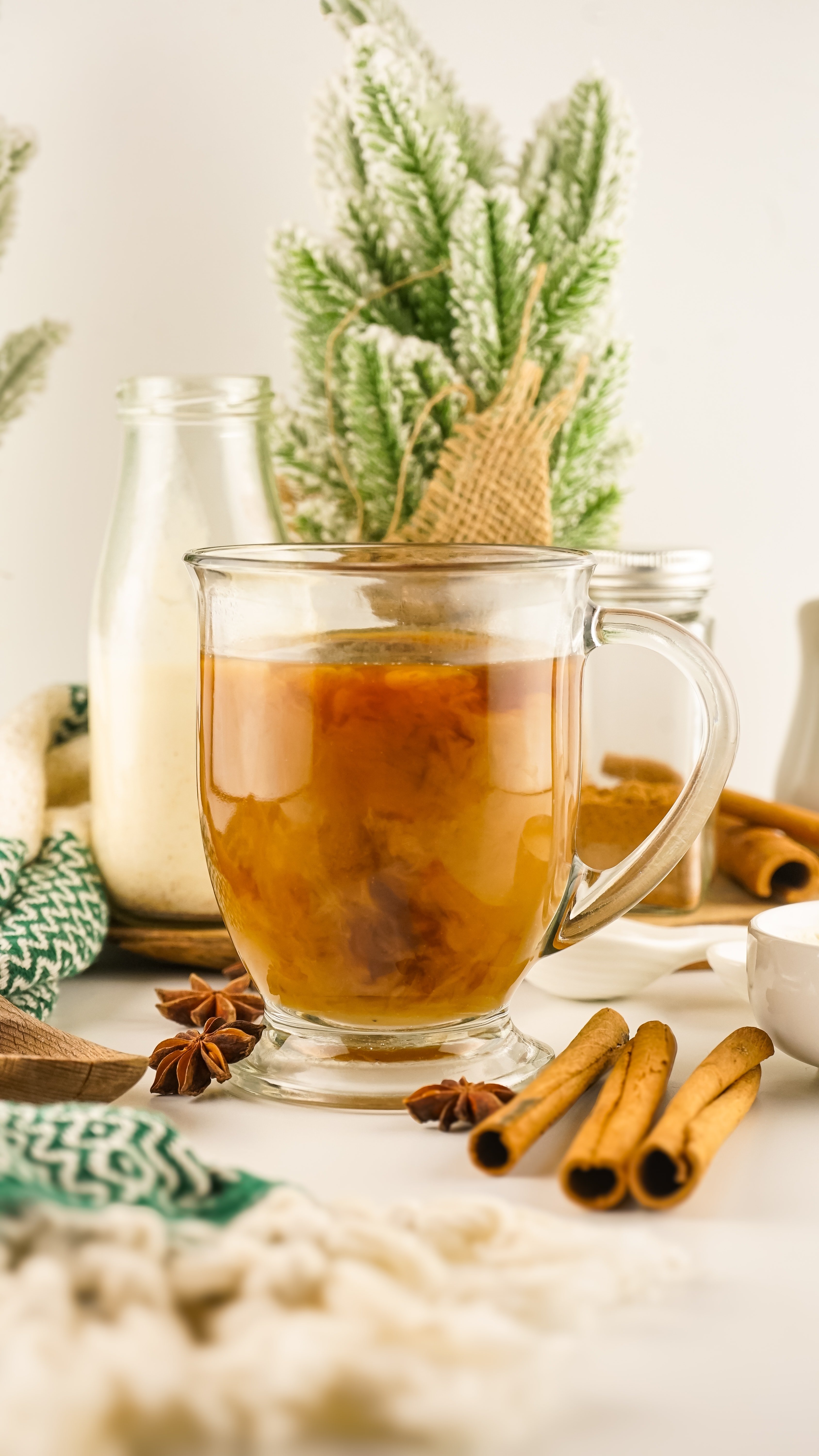 eggnog coffee creamer mixing with black coffee in a glass mug