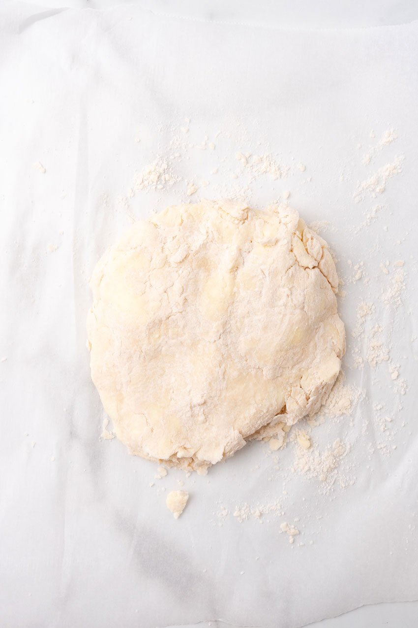 homemade puff pastry dough on a floured piece of white parchment paper