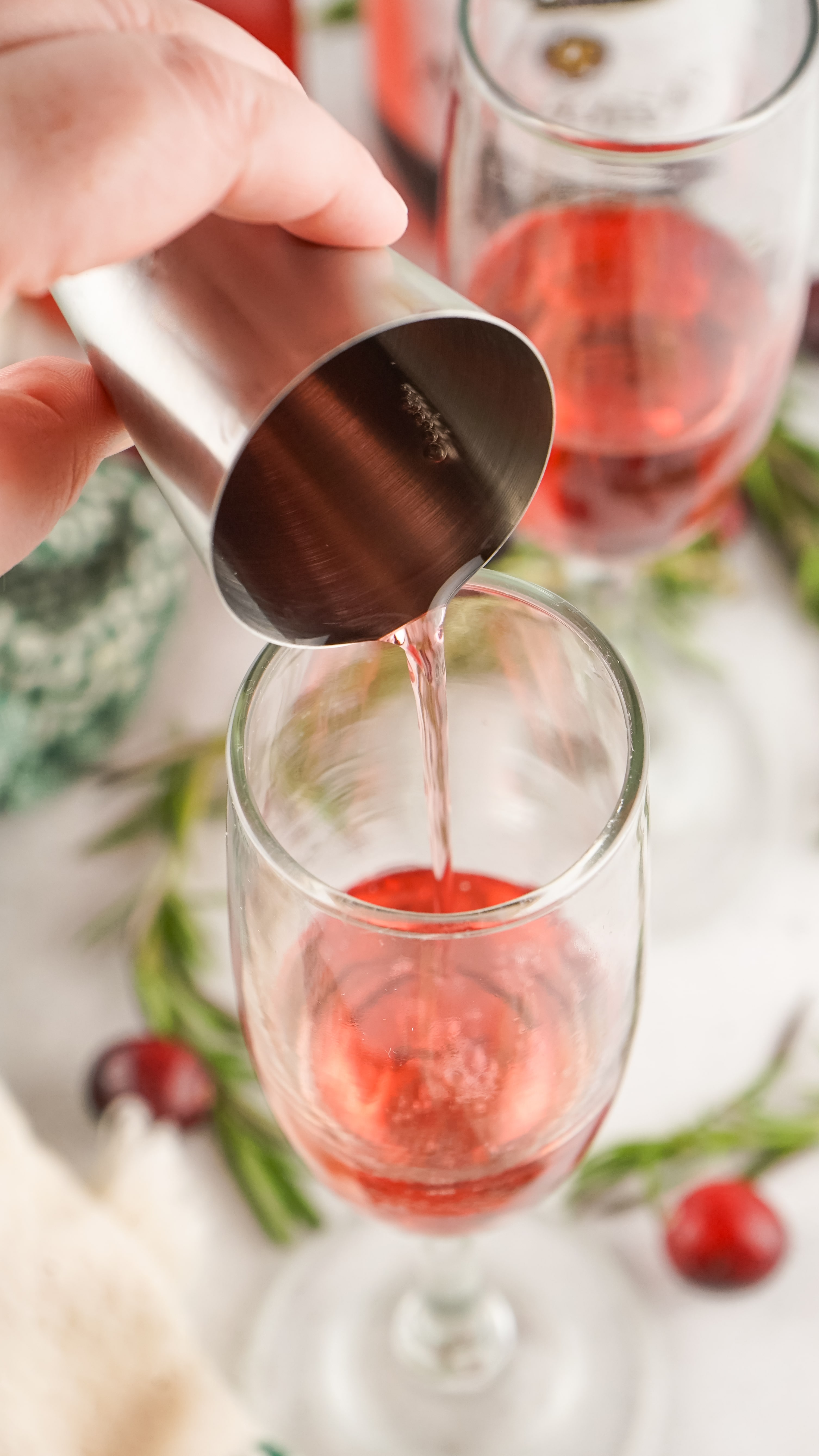 cranberry juice being poured into a fluted glass