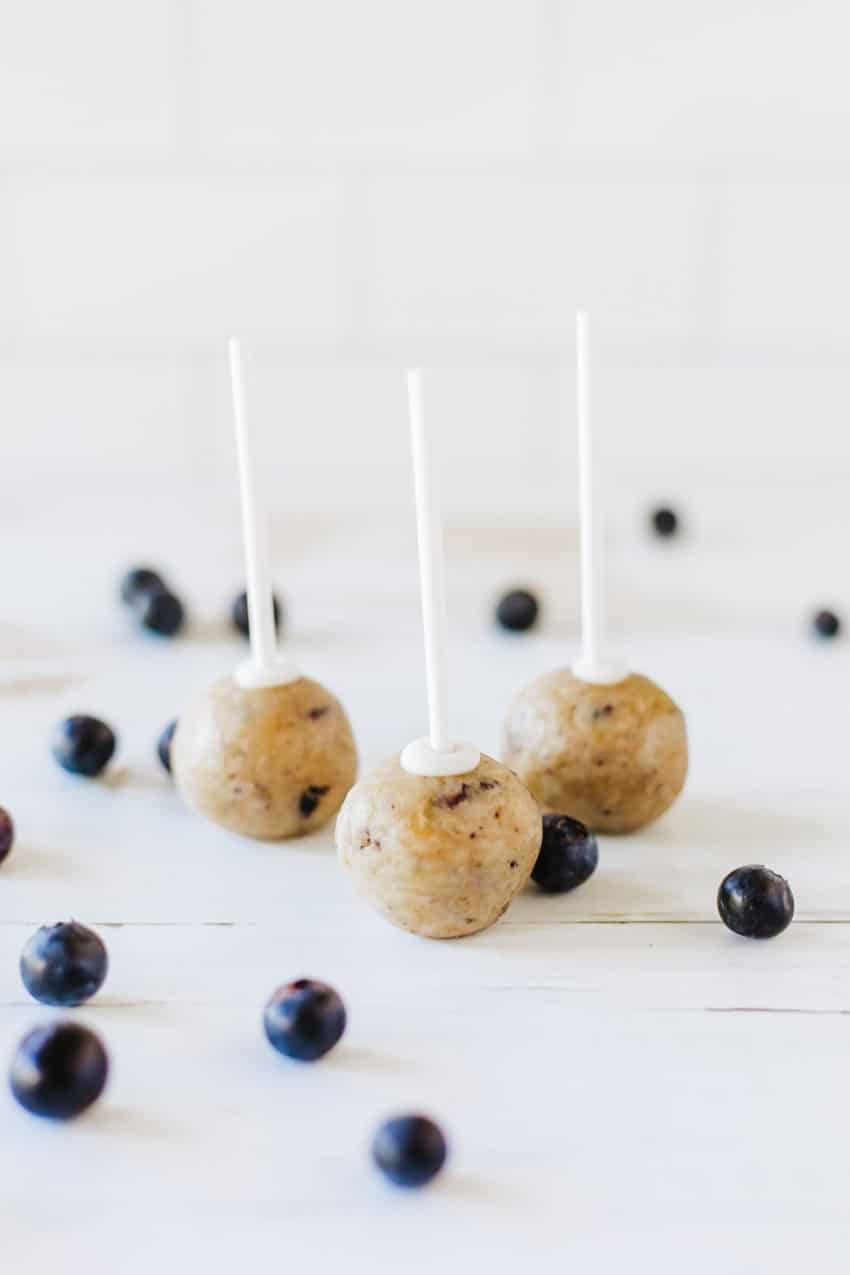 naked blueberry muffin cake pops sitting on a wooden table