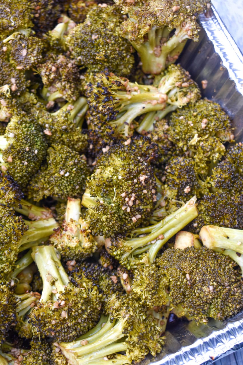 smoked broccoli recipe in an aluminum baking dish