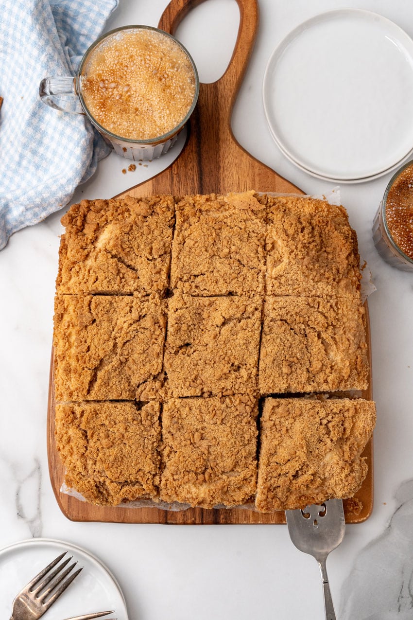 a bisquick coffee cake cut into squares on a wooden cutting board