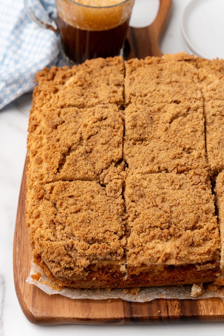 a bisquick coffee cake cut into squares on a wooden cutting board