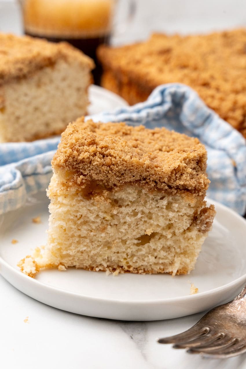 a slice of bisquick coffee cake on a small white dessert plate