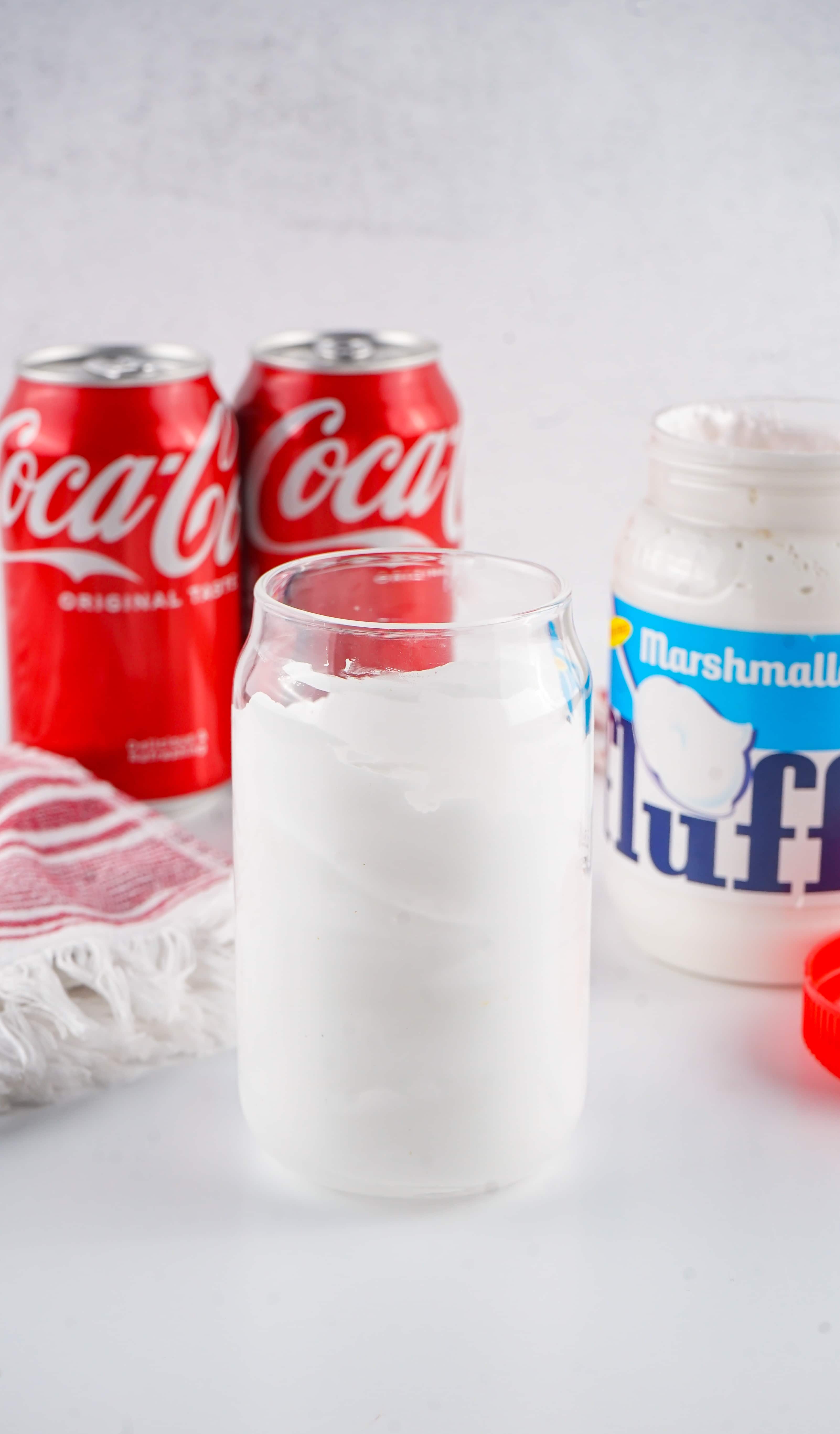 a glass jar coated on the inside with a thick layer of marshmallow fluff