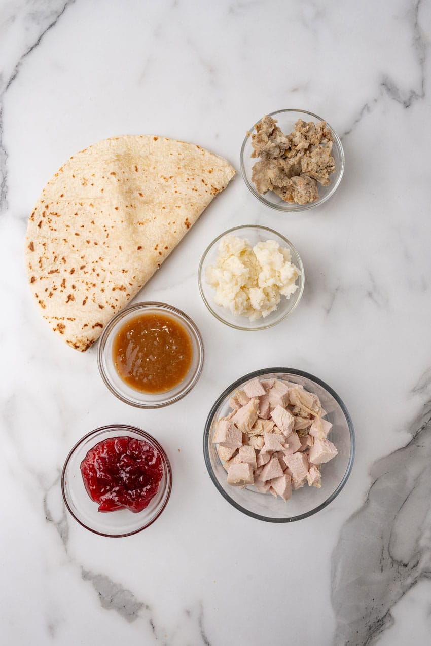 an overhead image showing the measured ingredients needed to make a batch of leftover turkey burritos