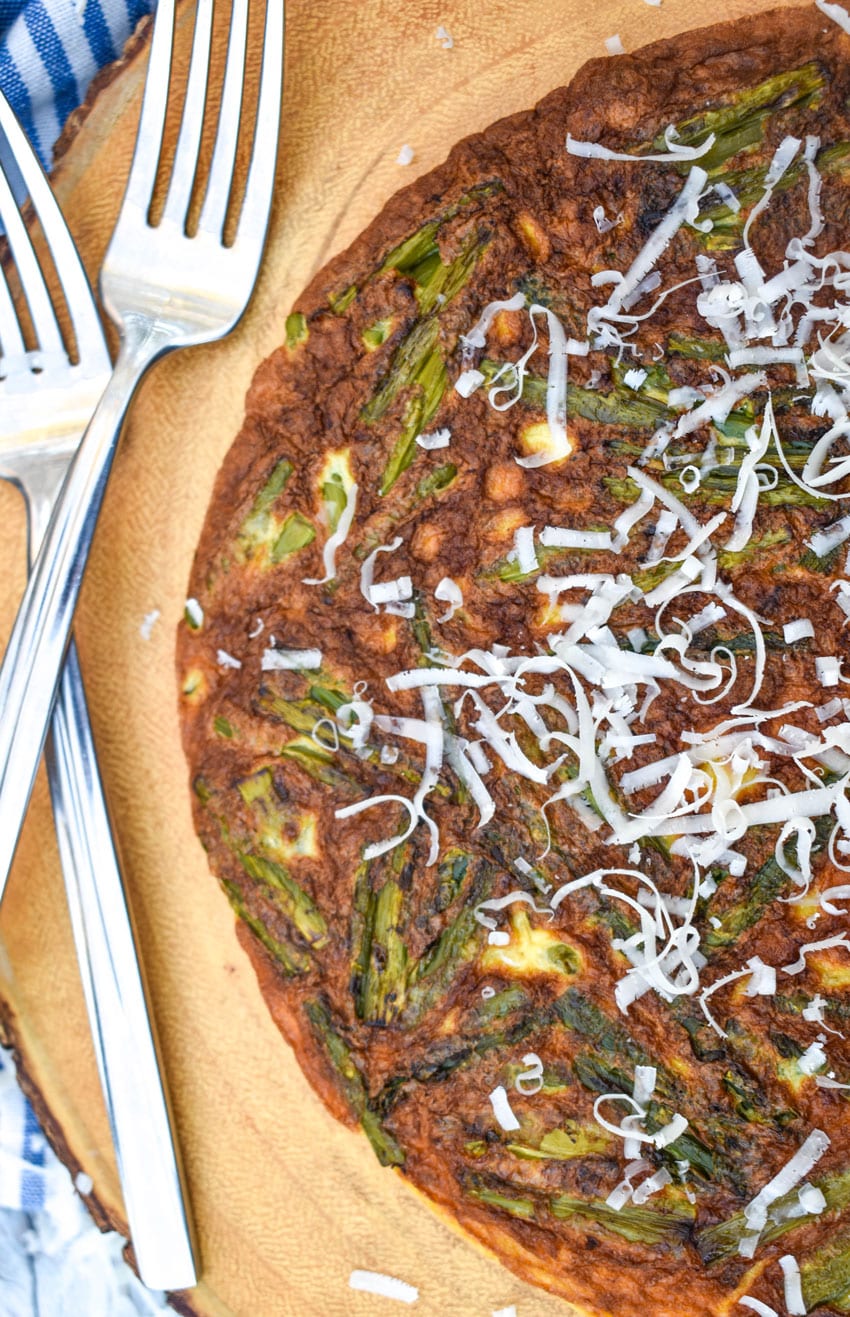 a cheddar asparagus frittata on a wooden cutting board