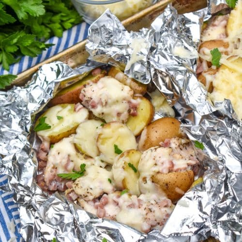 chicken cordon bleu foil packets on a metal baking tray