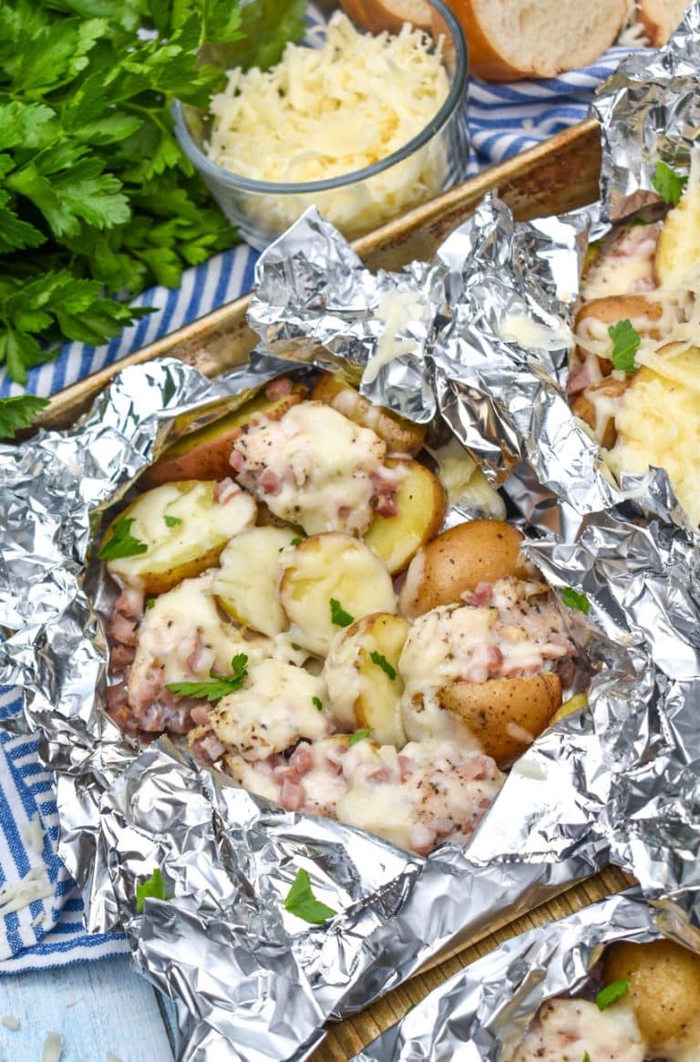 chicken cordon bleu foil packets on a metal baking tray