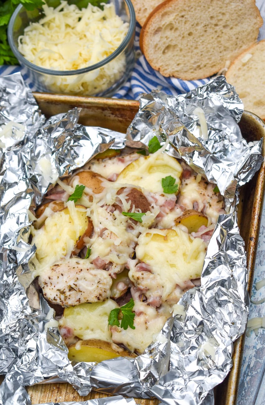 chicken cordon bleu foil packets on a metal baking tray