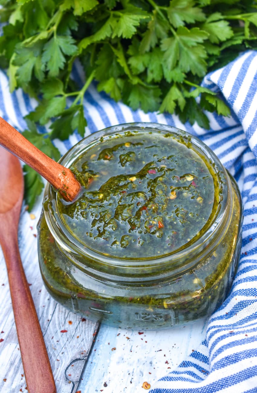 HOMEMADE CHIMICHURRI SAUCE IN A SMALL GLASS JAR