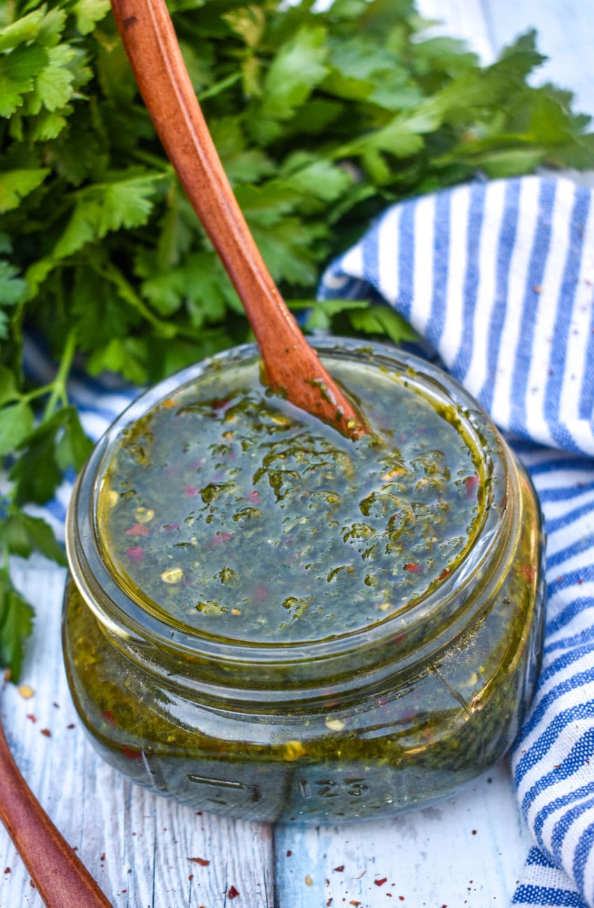 HOMEMADE CHIMICHURRI SAUCE IN A SMALL GLASS JAR