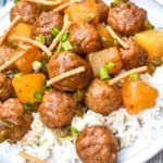 crockpot hawaiian meatballs over steamed white rice on a white dinner plate