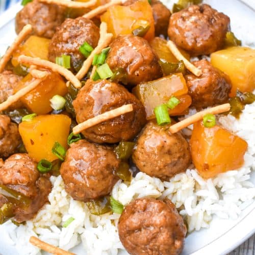 crockpot hawaiian meatballs over steamed white rice on a white dinner plate