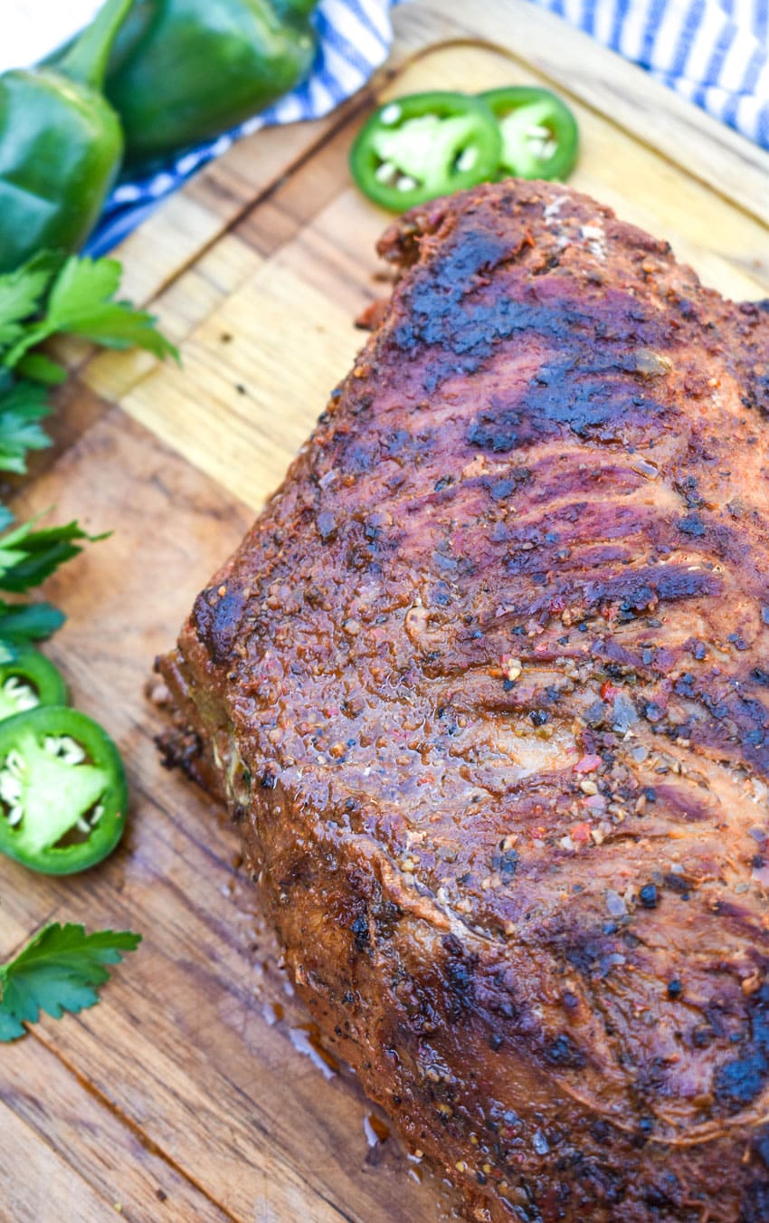 smoked tri tip on a wooden cutting board