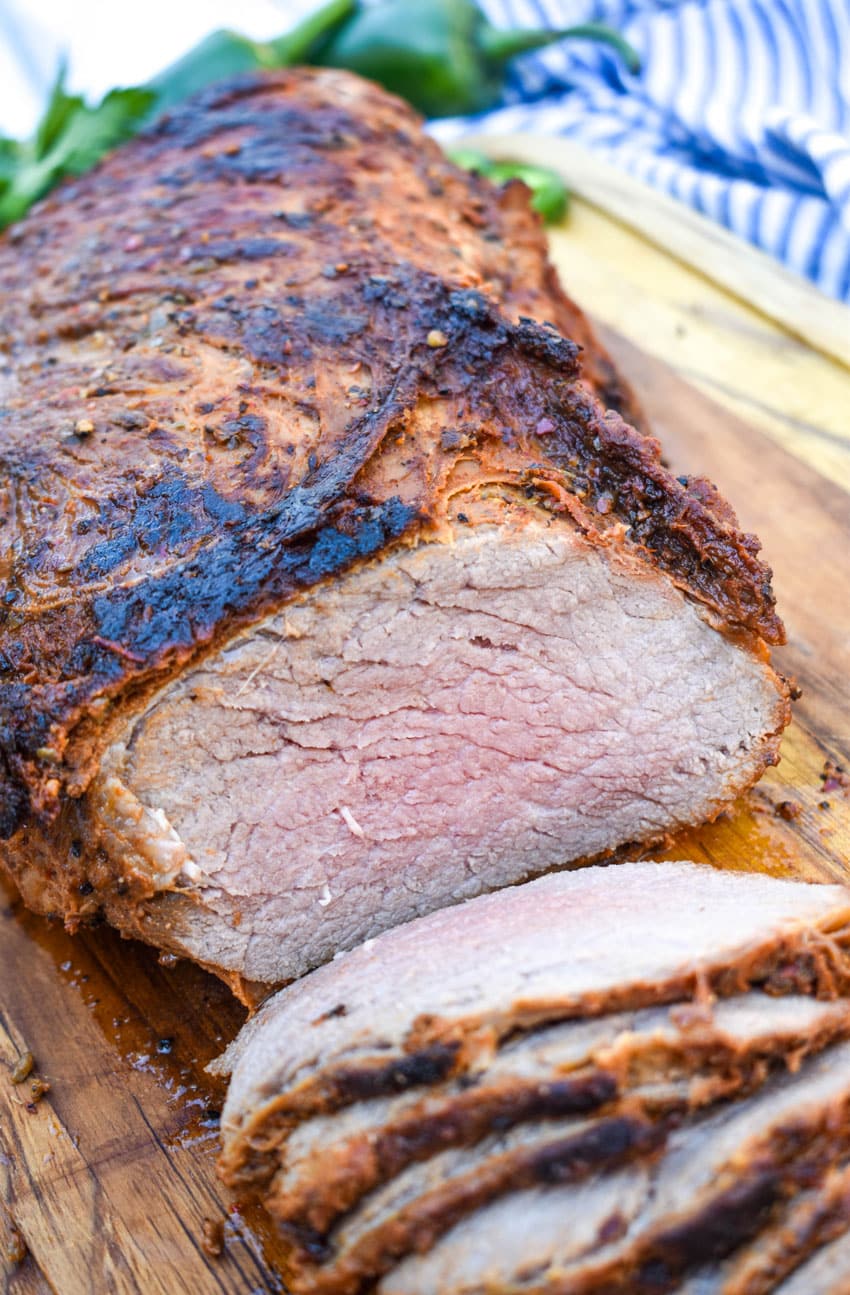 a sliced smoked tri tip on a wooden cutting board