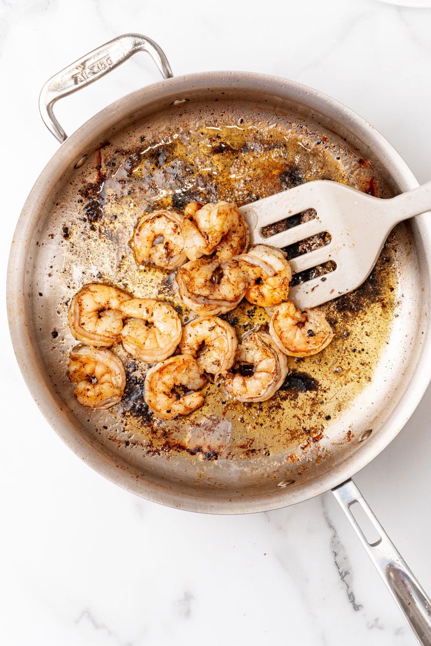 cooked shrimp in a large metal skillet