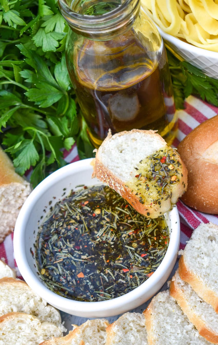 carrabba's bread dipping oil spread on a slice of baguette bread