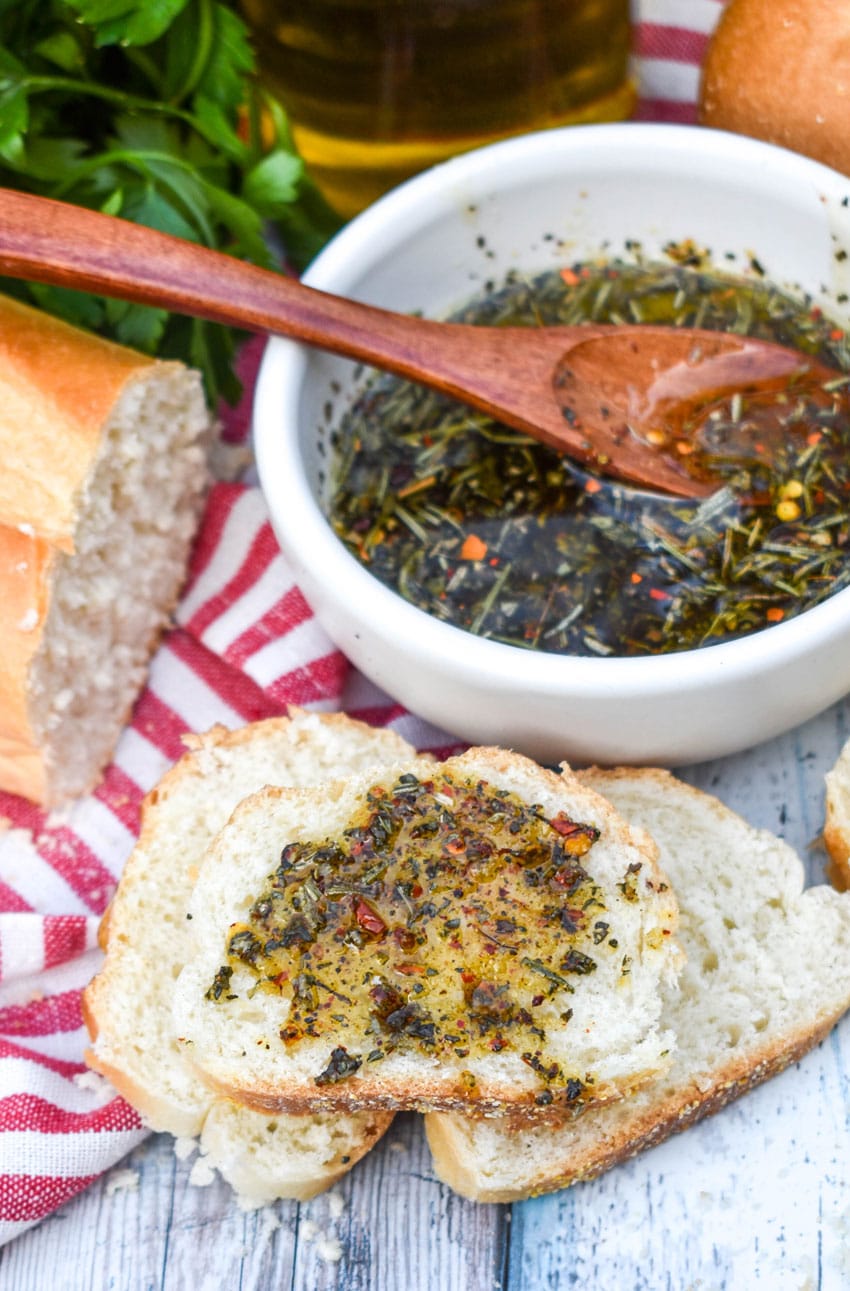 carrabba's bread dipping oil spread on a slice of baguette bread