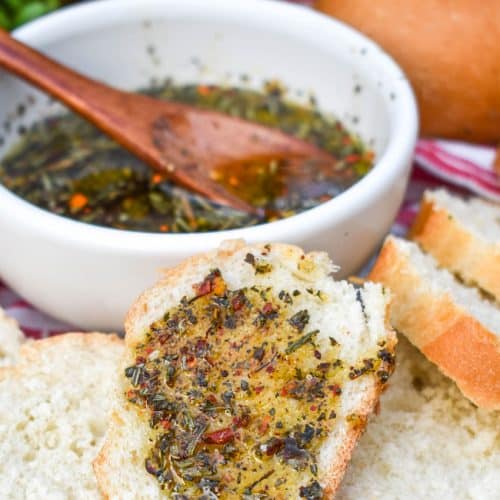 carrabba's bread dipping oil spread on a slice of baguette bread