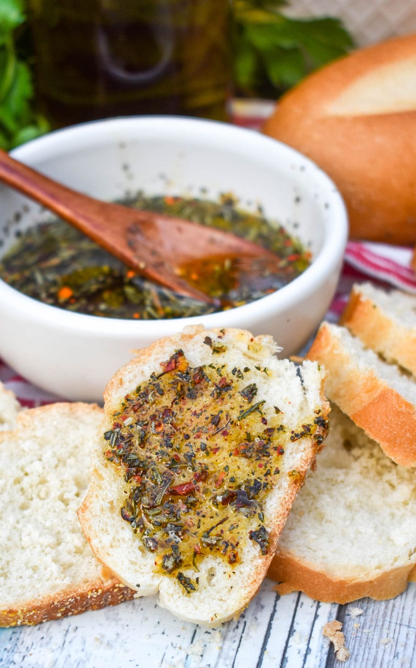 carrabba's bread dipping oil spread on a slice of baguette bread