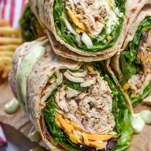 chick fil a chicken cool wraps cut in half and stacked on brown parchment paper